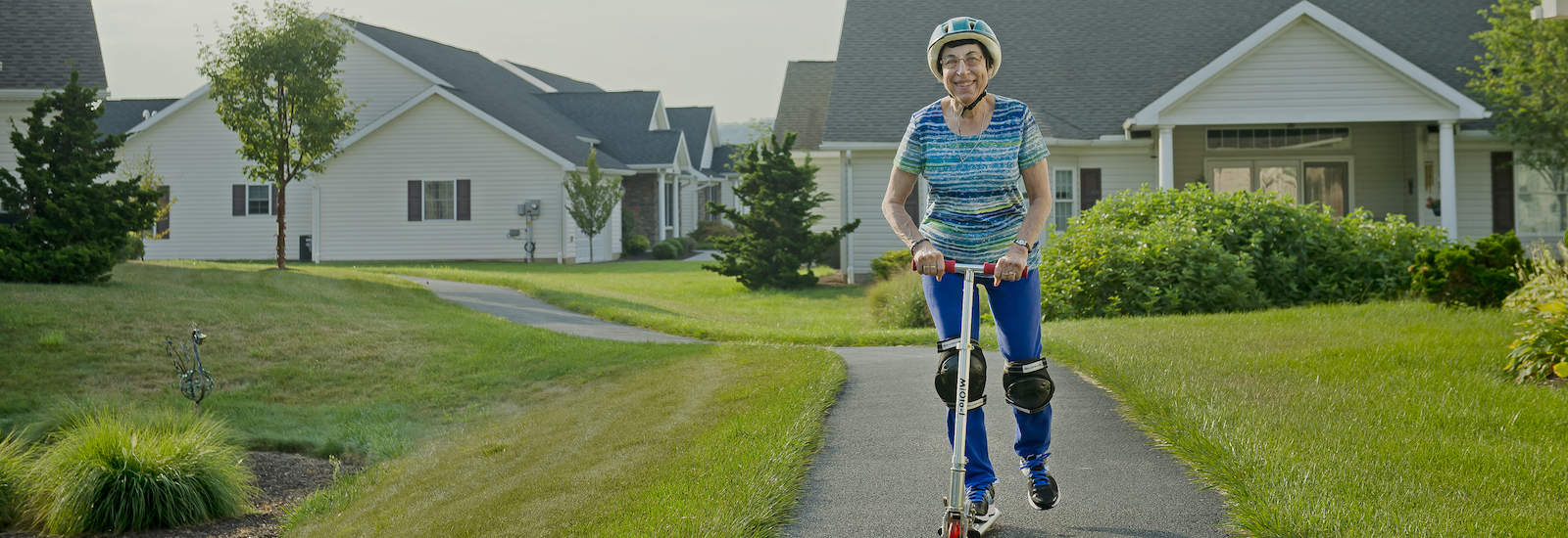 resident riding a scooter on the walkway of Bethany village