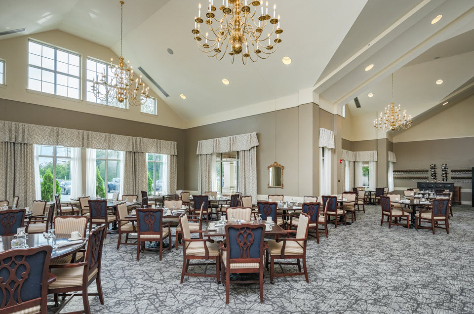 Spring Field's Restaurant at bethany village formal dining room with large windows and chandelier