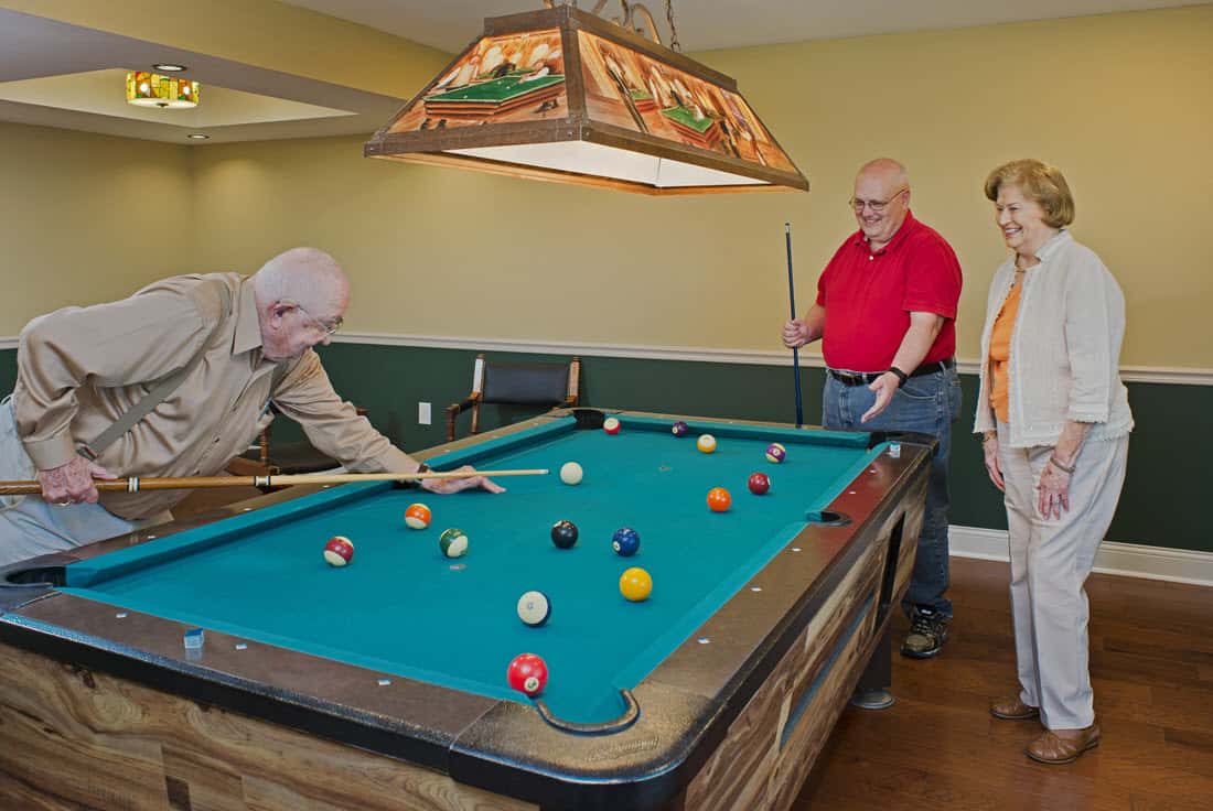 residents playing pool at Asbury place Kingsport clubhouse