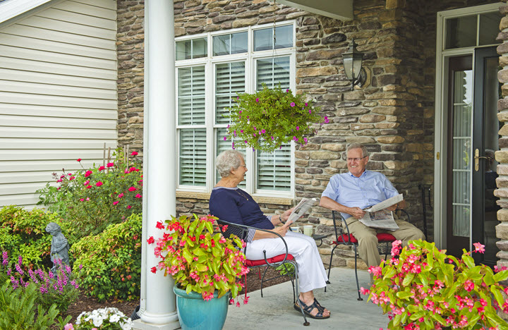 residents relaxing on the front porch Bethany West Cottage