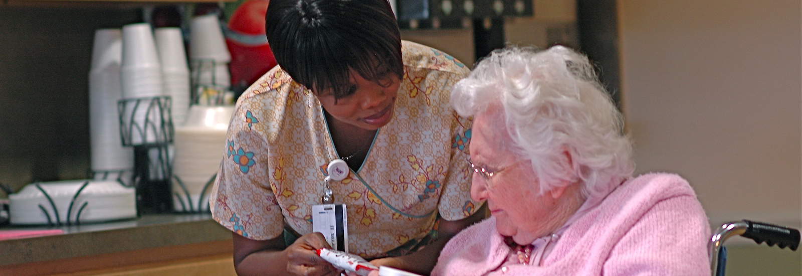 nurse assisting a memory care resident