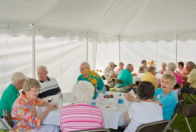 residents sitting together and celebrating at outdoor party
