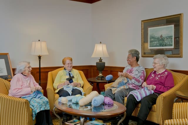 female residents gathering to crochet