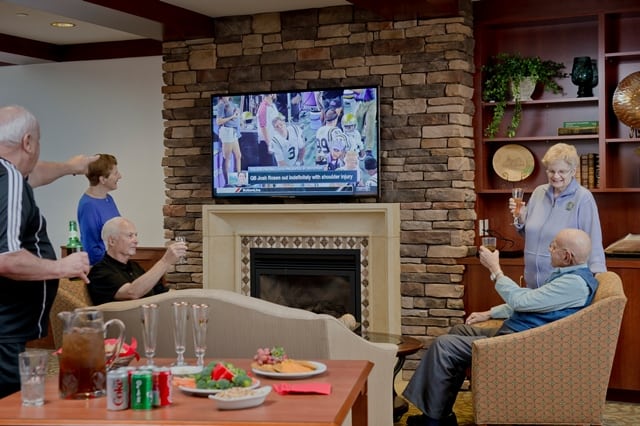 residents gathering together watching football