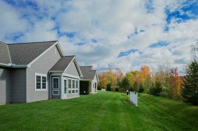 view of the grass and trees behind garden homes