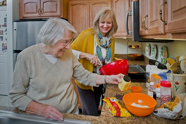 volunteer assisting resident with cooking