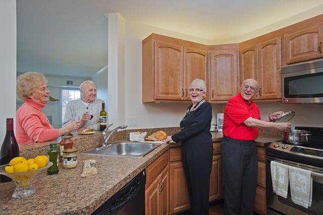 residents hosting friends in kitchen of their home