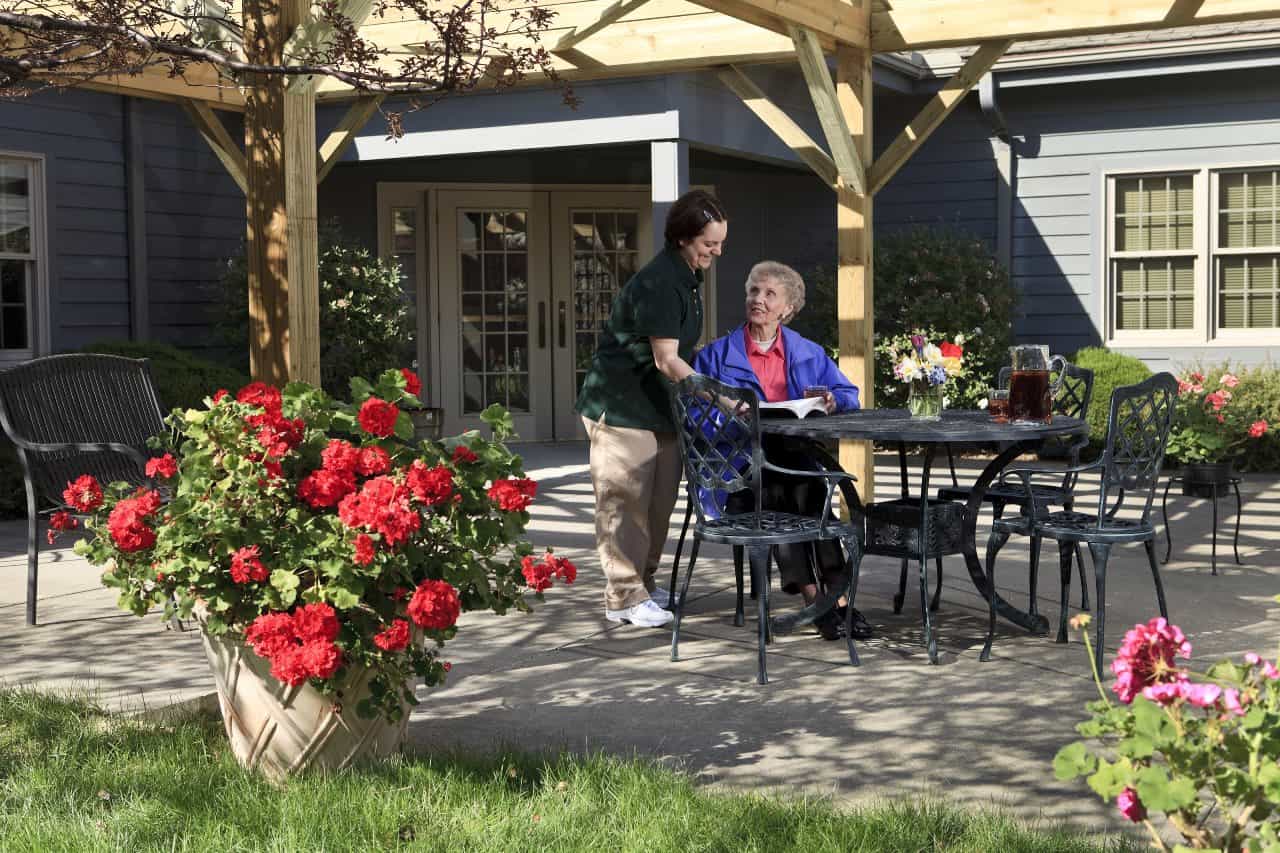 resident relaxing on the patio at Woodlands memory support unit