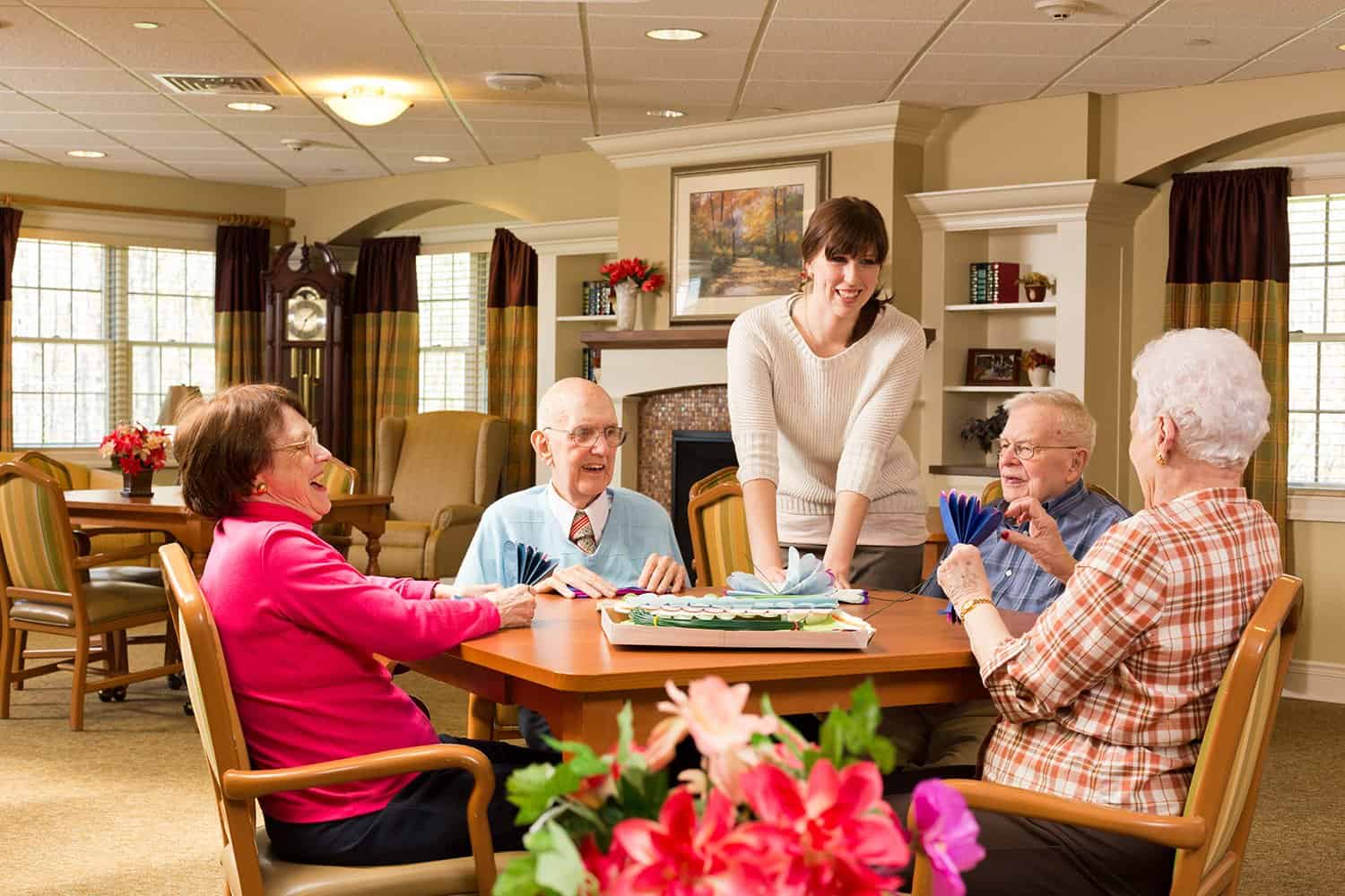 residents and staff chatting together in the dining area