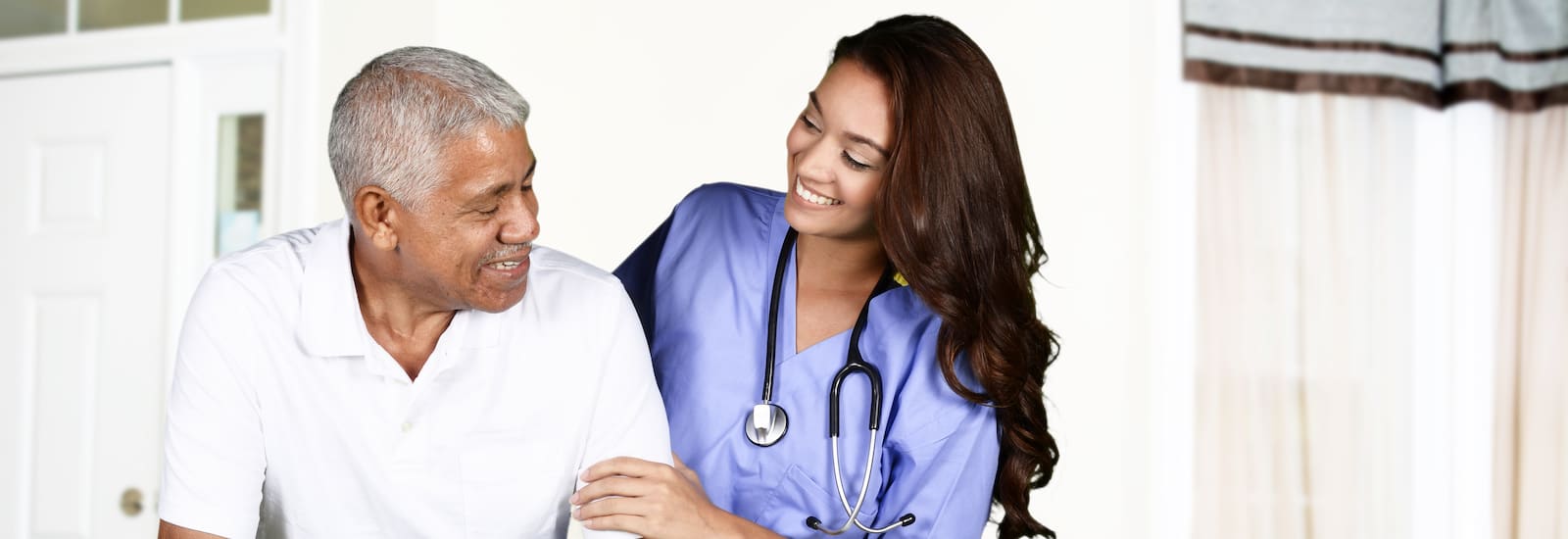 Health care worker helping an elderly man