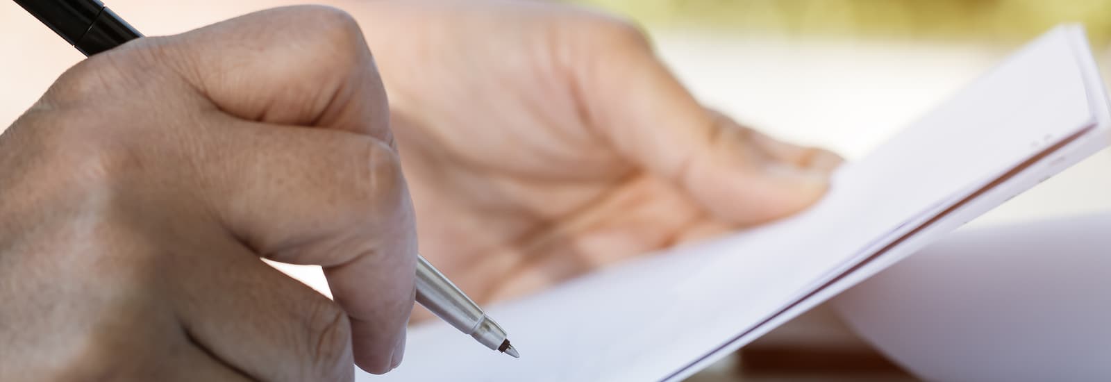 hand with paper and documents