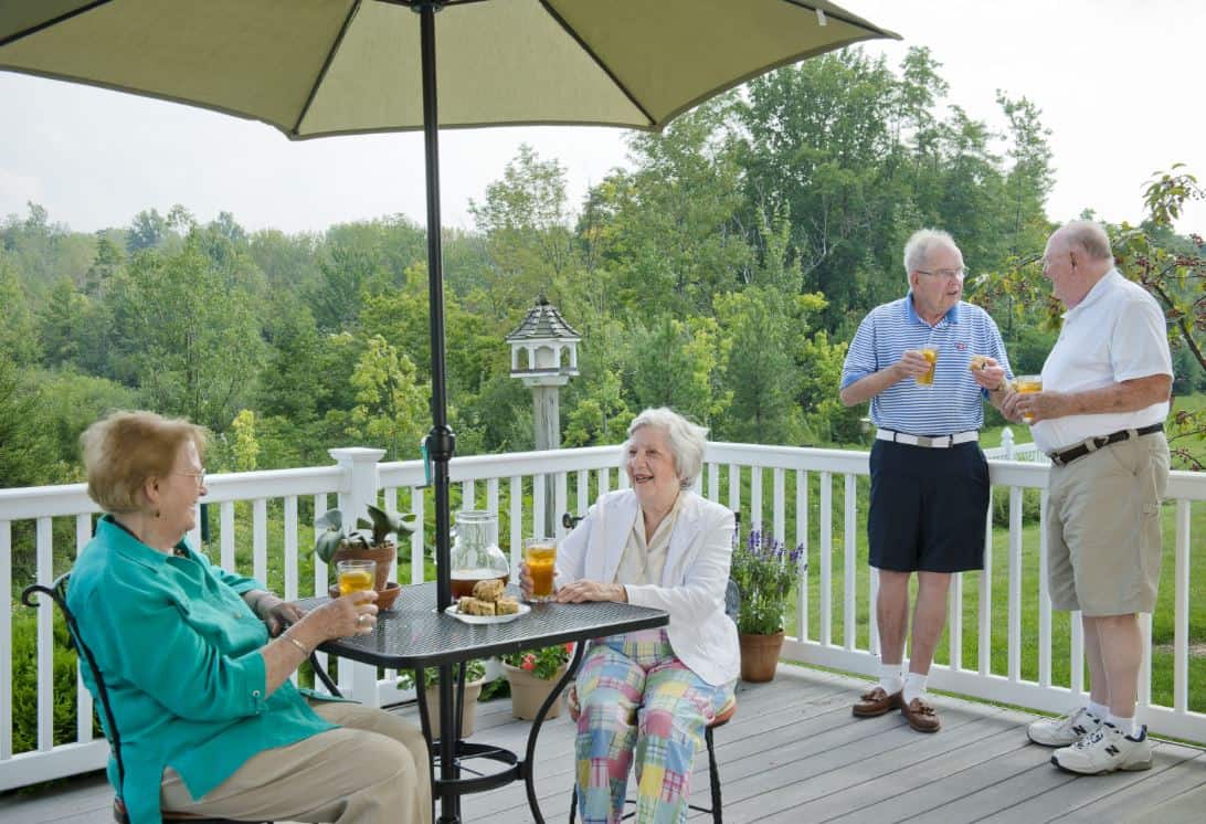 residents socializing on the back deck of a garden home