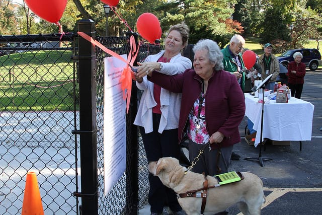 resident taking dog to park