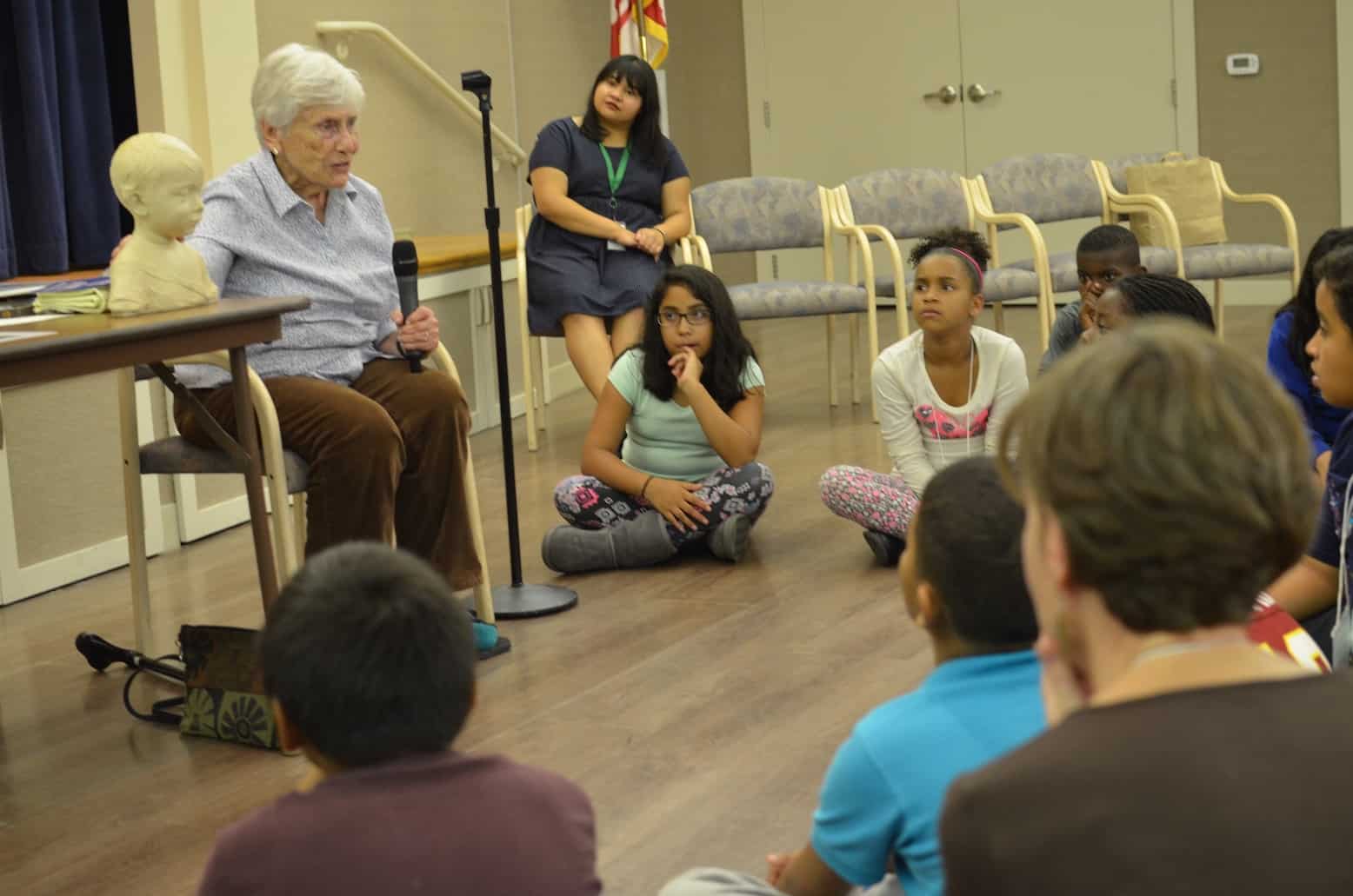 senior talking to children