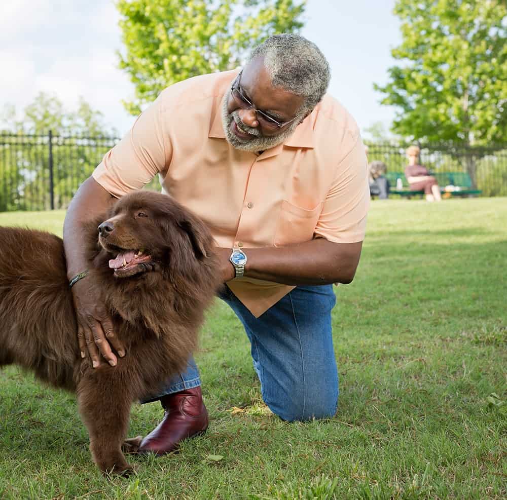 resident with his dog enjoying a walk