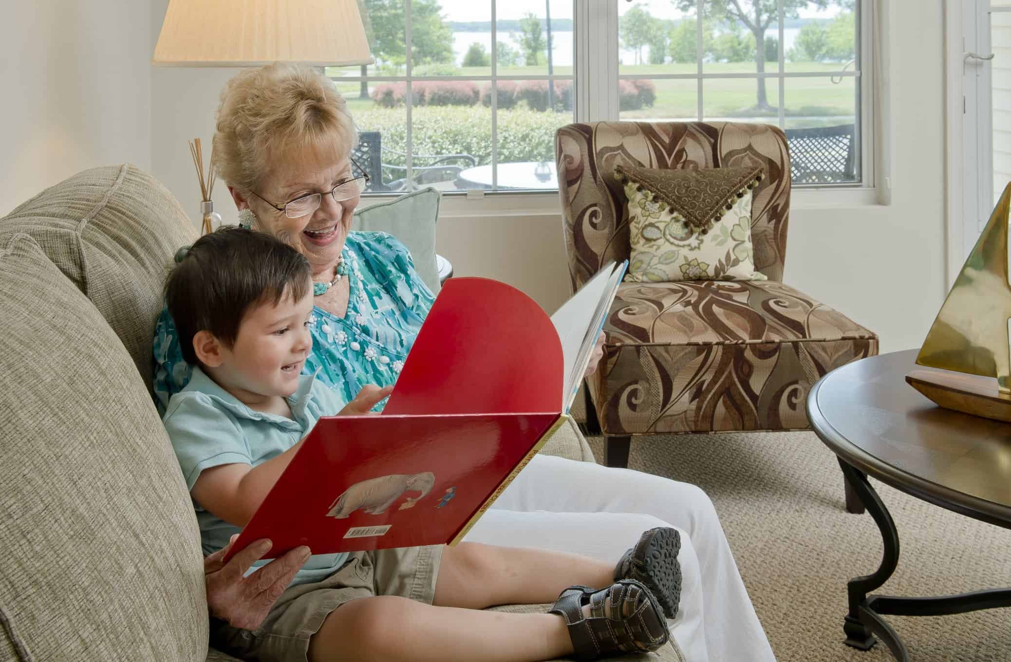 grandmother and grandson reading inside cottage home