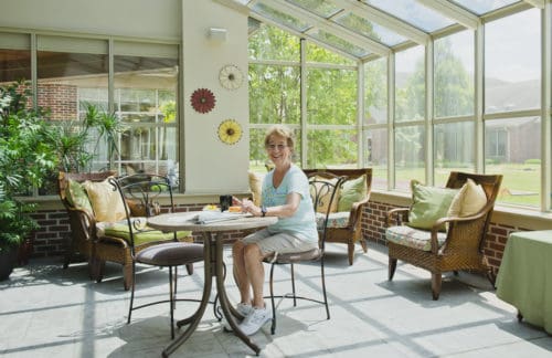 resident relaxing in the sunroom