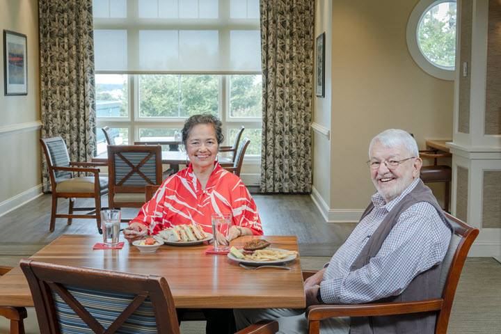older man and woman having lunch together in dining room