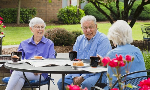 residents enjoying coffee at the courtyard patio