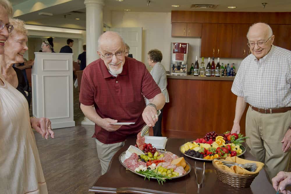 residents enjoying food during happy hour