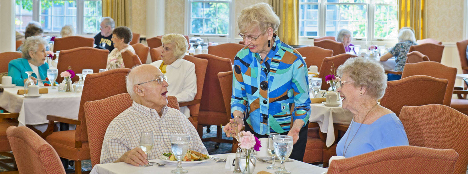 residents enjoy visiting in the dining room