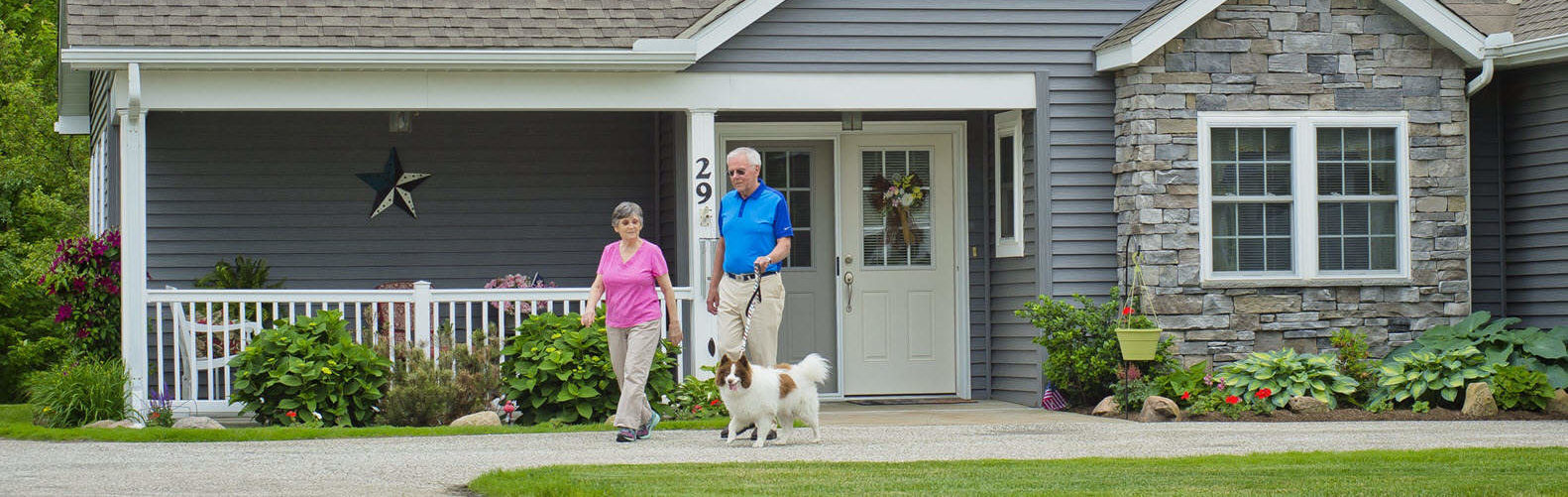 residents walking their dog outside of the garden homes