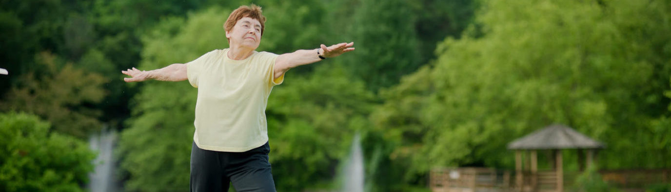 senior woman doing yoga outside