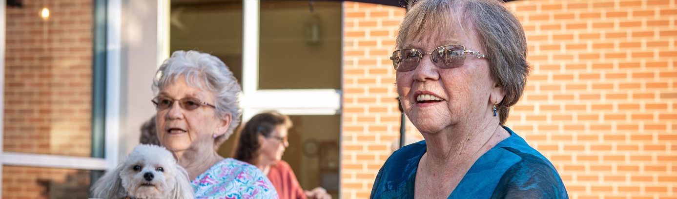 residents sitting outside at Asbury Normandie Ridge