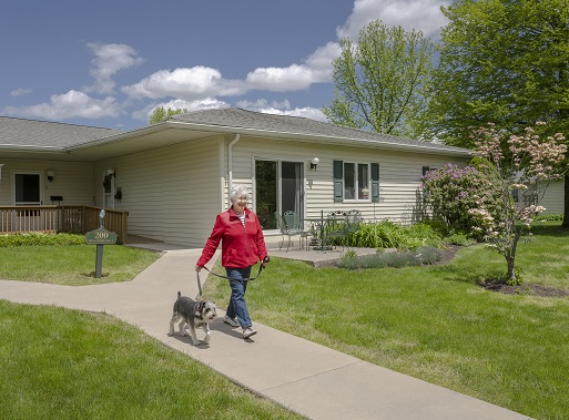 resident walking her dog on the paths of riverwoods