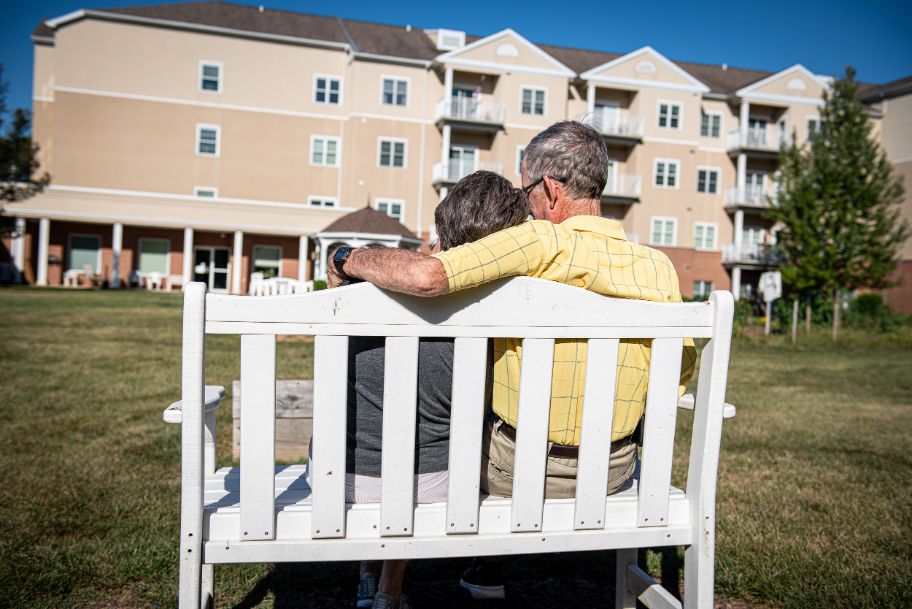 resident couple enjoying time outdoors on a bench