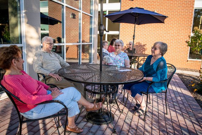 residents enjoying the outdoor patio at Normandie Ridge