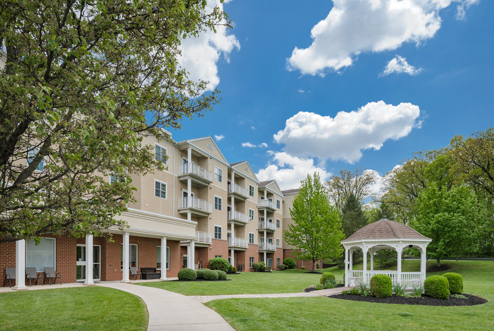 rear of Normandie Ridge apartments with balconies overlooking large lawn and gazebo