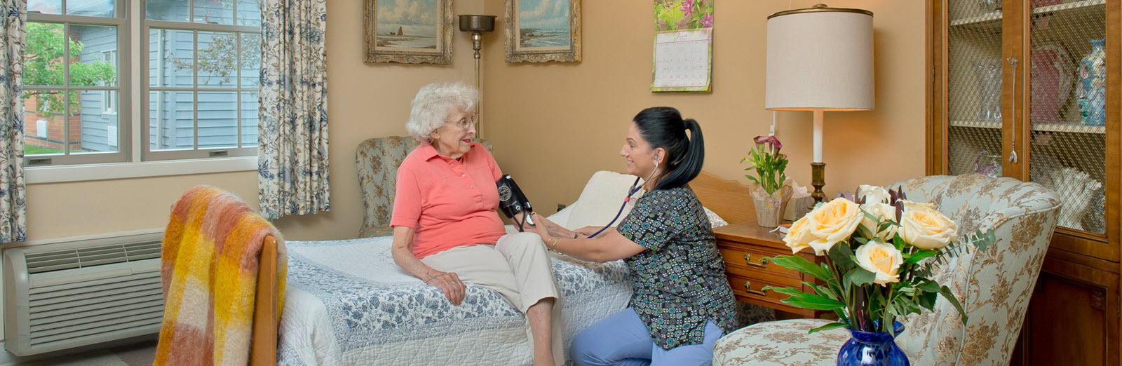 resident getting blood pressure checked by nurse