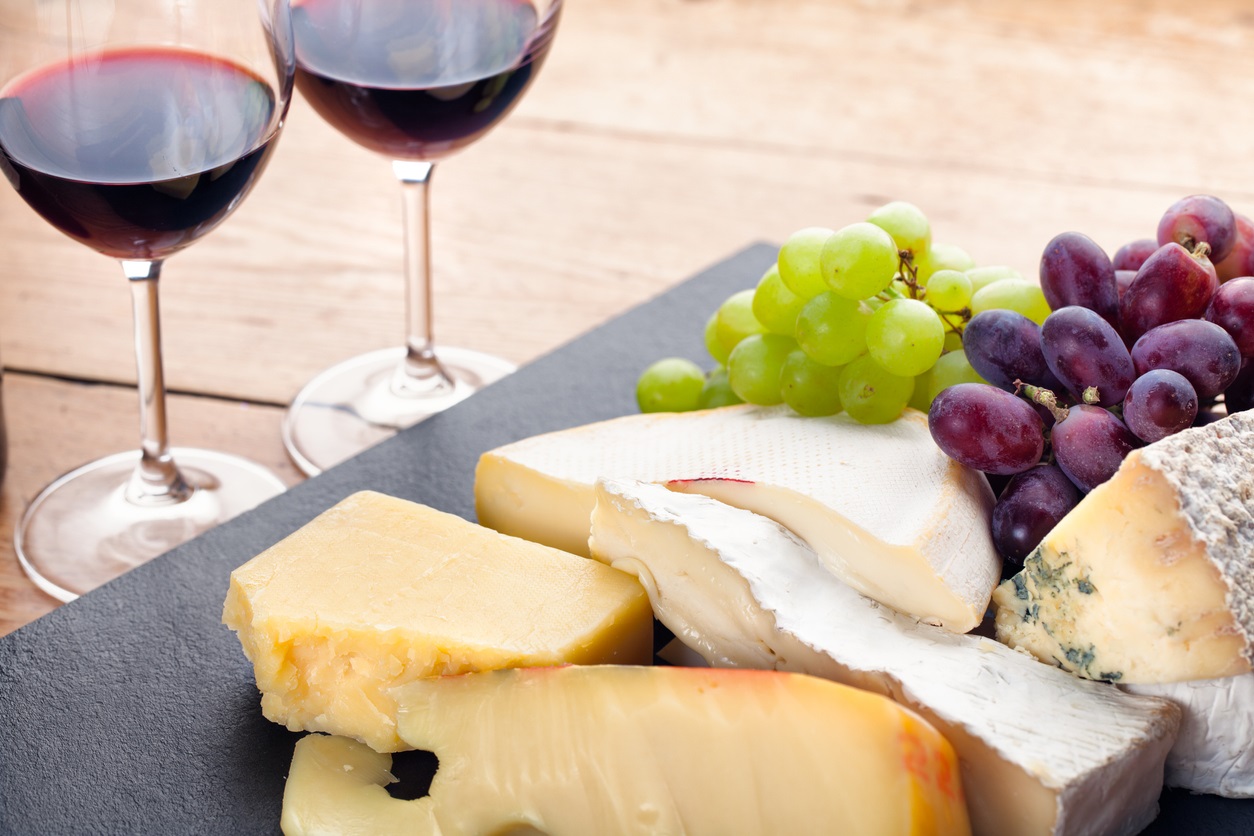 A selection of cheeses and red wine