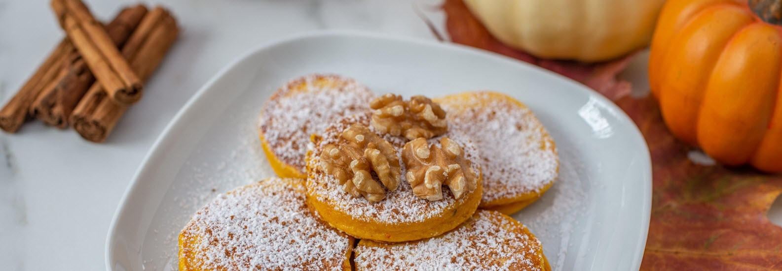 pumpkin fritters on plates on a fall table