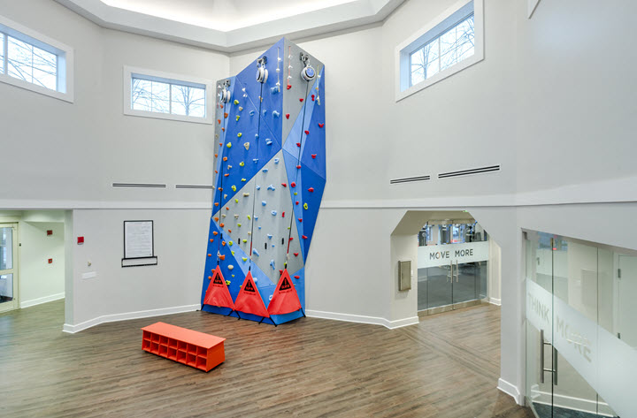 atrium of wellness center with rock wall