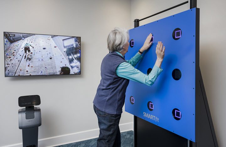 woman uses smartfit exergaming board at wellness center