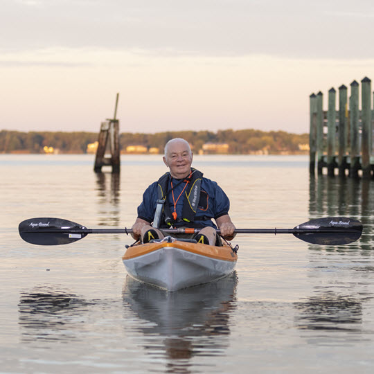 senior man in kayak by Asbury Solomons dock