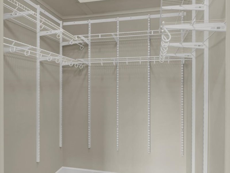 Empty walk-in closet with lots of shelving