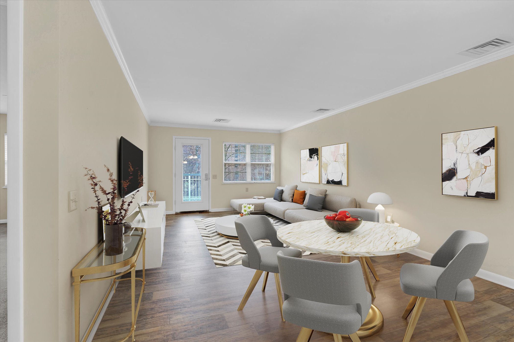 dining area with round table and four chairs looking into living room with large windows and french door