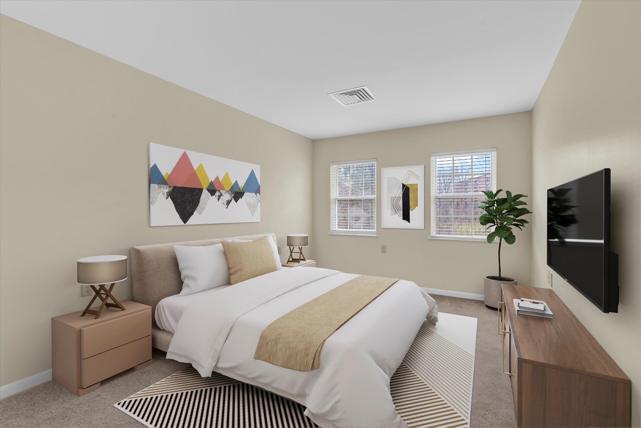 bedroom with large bed and two windows, side table and dresser at foot of bed