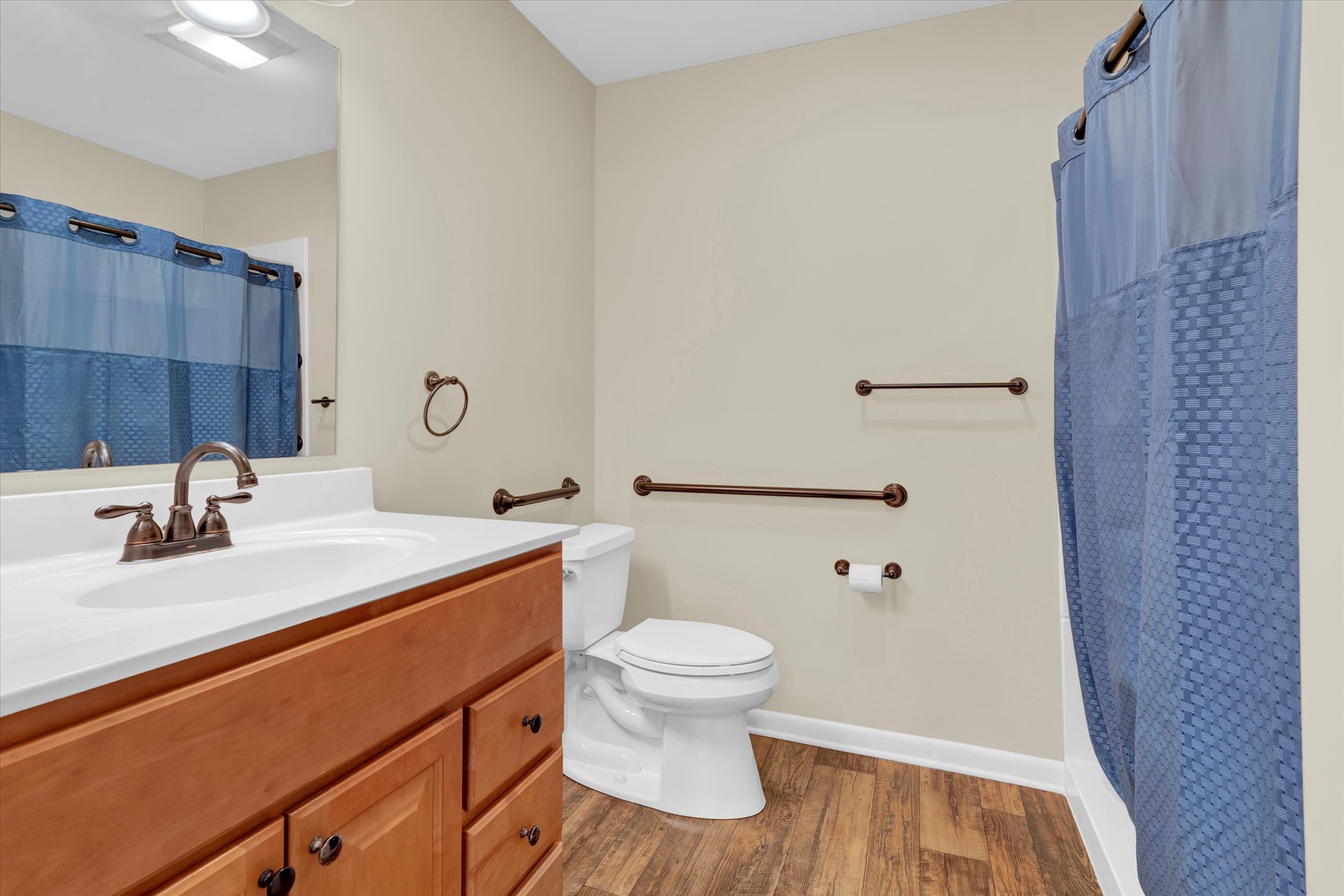 bathroom with oak sink cabinets and walk in shower