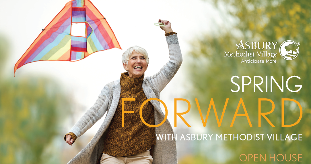 smiling senior woman in brown turtle neck runs outside holding a rainbow kite