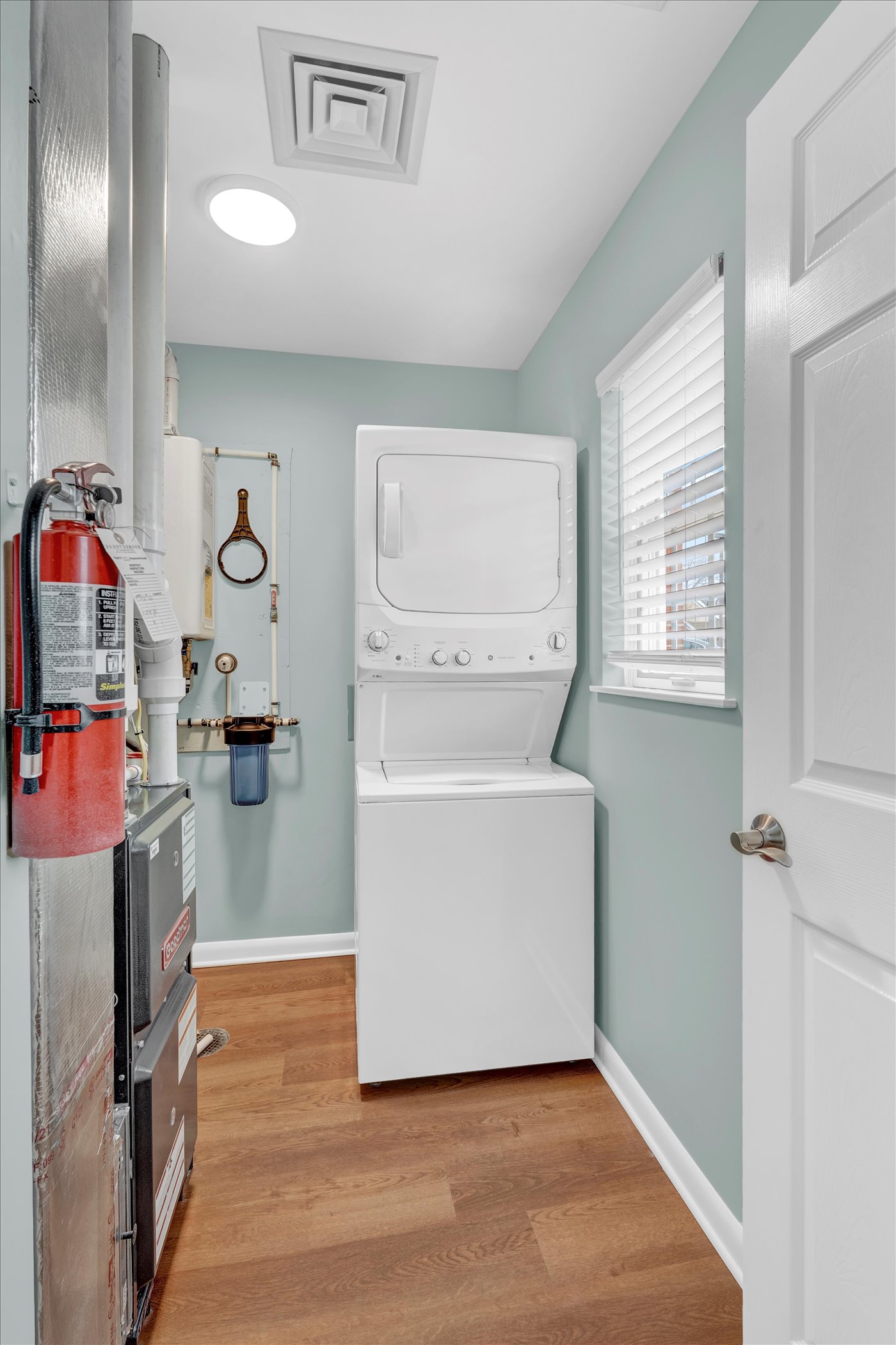 laundry room with stackable washer and dryer