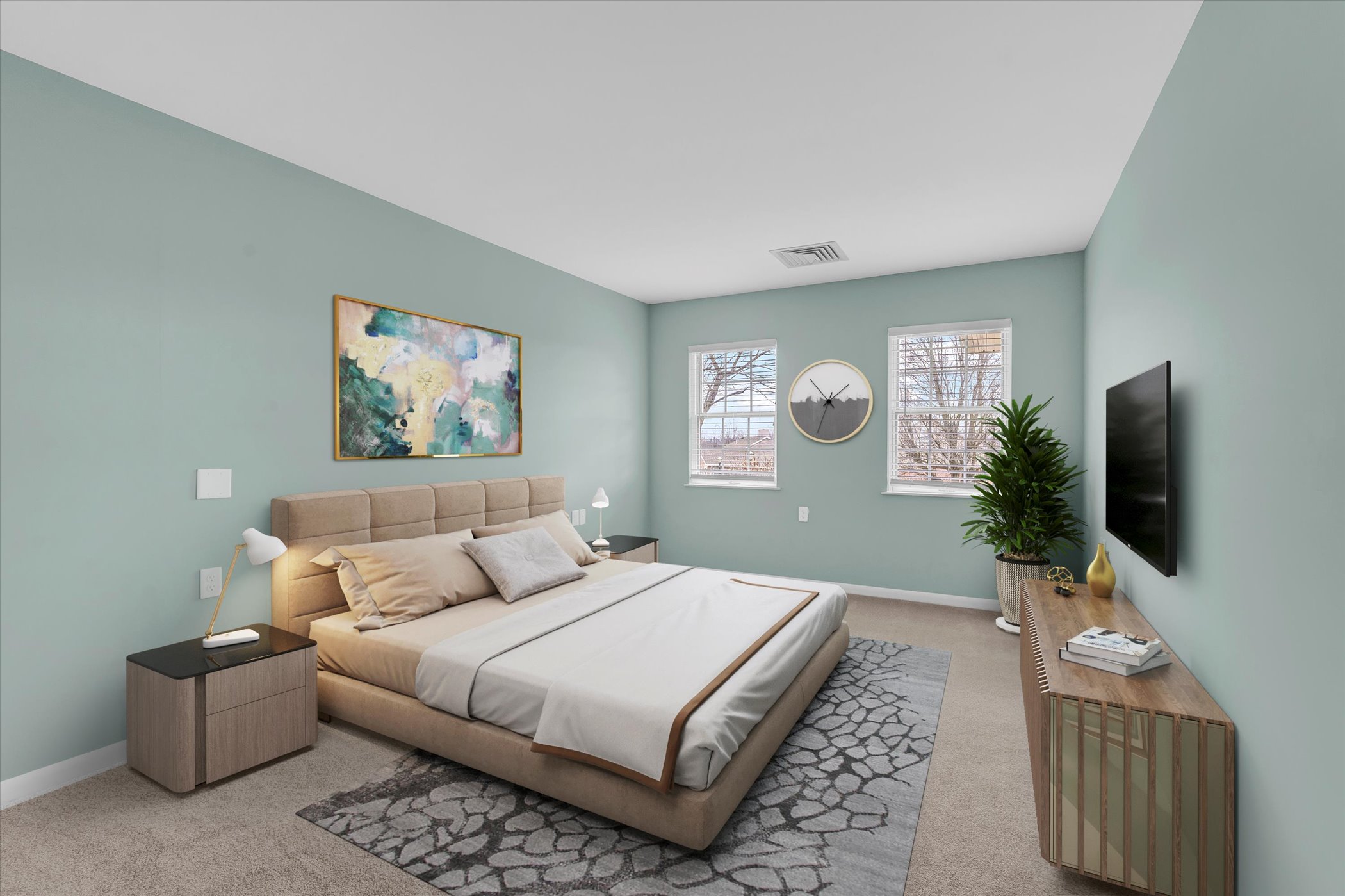 bright bedroom with two windows, mirror, and large bed with abstract painting and side table