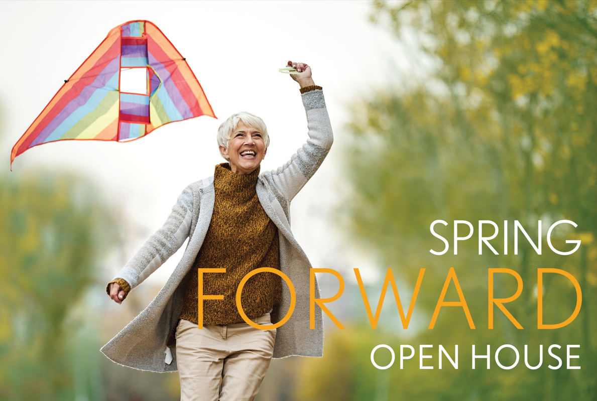 elderly female flying kite outdoors in springtime