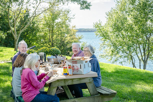 seniors at a picnic table having a crab feast