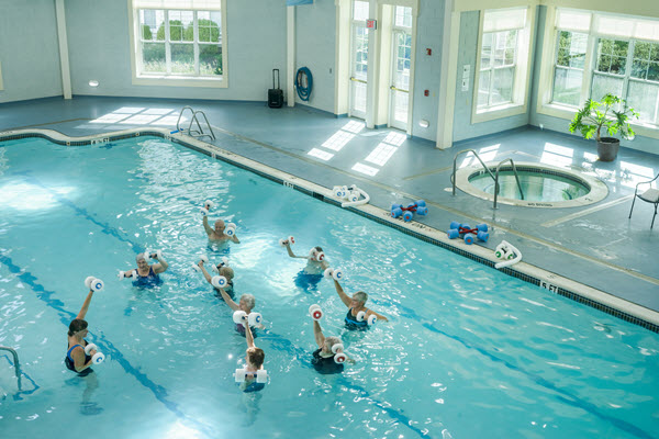 group of seniors in pool doing water aerobics