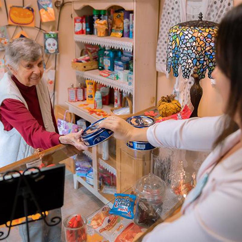 older woman purchasing cookies at a store