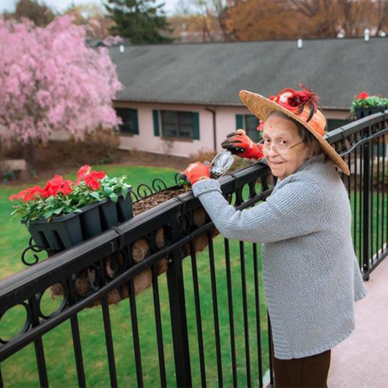 senior woman gardening on balcony